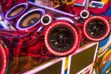 colorful lights of stereo and speakers in car in the night