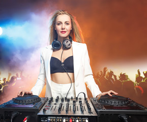 Beautiful blonde DJ girl on decks - the party,