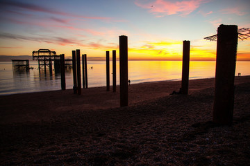 Remains of Brighton Pier left standing in sea at sunset, Brighton