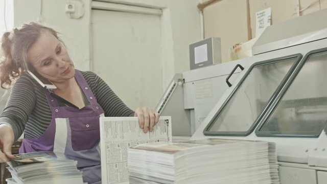 Polygraph printing process - a woman speak telephone and make manual labor