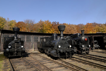 Obraz premium Old Vintage Steam Locomotive At The Train Depot 