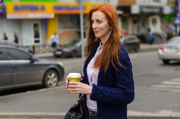 Fototapeta premium Young red woman with hot coffee