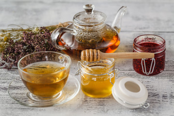 Cup of herbal tea with wild flowers and various herbs