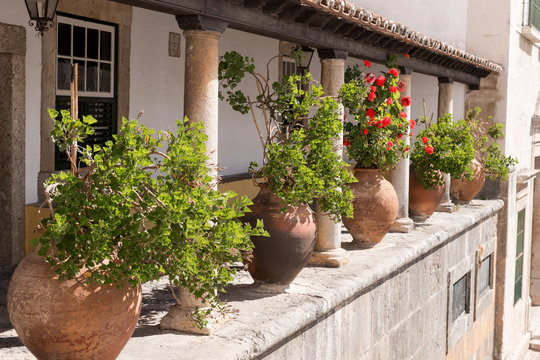 Big ceramic pots between the columns at the terrace of old house