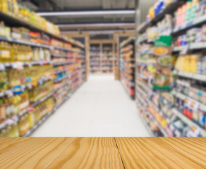 Wooden board empty table in front  Blur of condiment shelf produ
