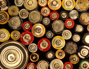 Old electric batteries on black background