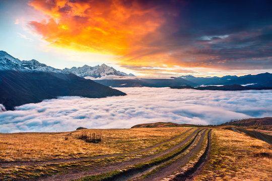 Fototapeta Foggy autumn morning at the foot of Mt. Tetnuld in Caucasus moun