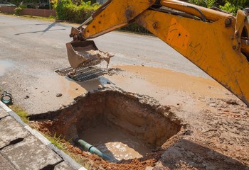 Fototapeta premium Excavator working on the Repair of pipe water 