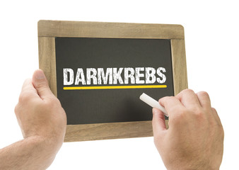 Darmkrebs / Hand schreibt auf Kreidetafel