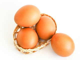 eggs in a small basket on white background.