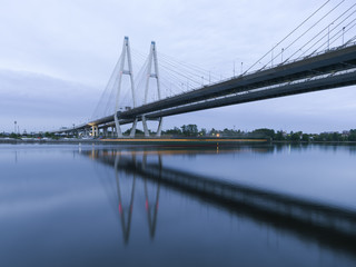 Fototapeta na wymiar Bolshoy Obukhovsky Bridge (Cable stayed Bridge) at the summer morning light with the shadow of ship, Saint-Petersburg, Russia
