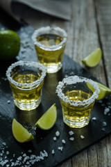 Fototapeta na wymiar Gold tequila with lime and salt