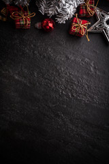 Christmas tree with decoration on dark stone background