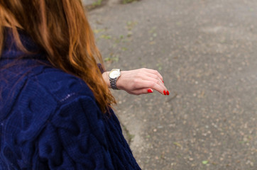 Close up of young woman looking at her watch