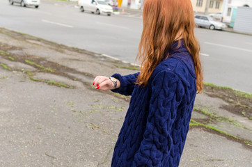 Close up of young woman looking at her watch