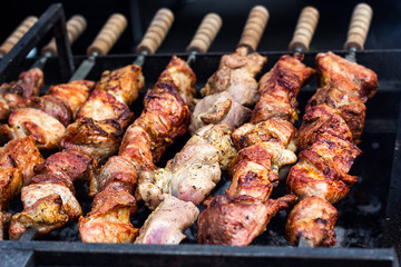 Marinated shashlik preparing on a barbecue grill over charcoal. Shashlik or Shish kebab popular in Eastern Europe. Shashlyk (skewered meat) was originally made of lamb. Roast Beef Kebabs On BBQ Grill.