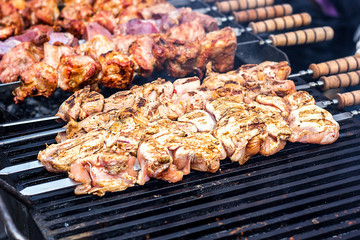 Marinated shashlik preparing on a barbecue grill over charcoal. Shashlik or Shish kebab popular in Eastern Europe. Shashlyk (skewered meat) was originally made of lamb. Roast Beef Kebabs On BBQ Grill.
