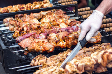 Marinated shashlik preparing on a barbecue grill over charcoal. Shashlik or Shish kebab popular in Eastern Europe. Shashlyk (skewered meat) was originally made of lamb. Roast Beef Kebabs On BBQ Grill.