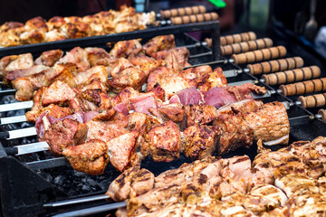 Marinated shashlik preparing on a barbecue grill over charcoal. Shashlik or Shish kebab popular in Eastern Europe. Shashlyk (skewered meat) was originally made of lamb. Roast Beef Kebabs On BBQ Grill.