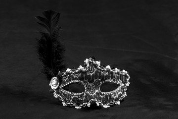 black white female theatrical mask with feather