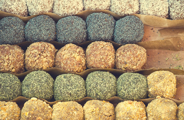 Colorful healthy homemade candies with nuts, dry fruits and spices