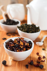 Fruit tea in a white ceramic bowl on a wooden table. Selective focus.