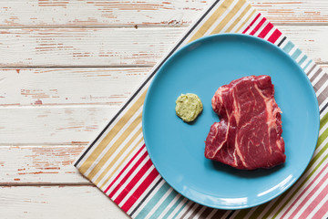 Raw steak on wooden table