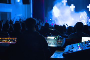 Soundman working on the mixing console.