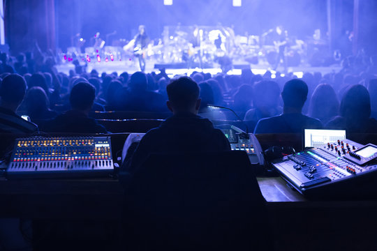 Soundman working on the mixing console.