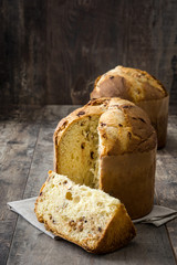 Christmas cake panettone on a rustic wooden background

