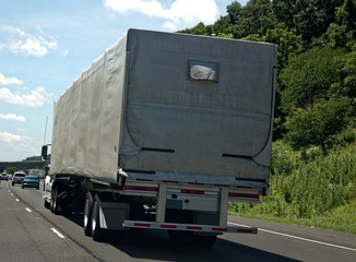 Rear View of Covered Semi Truck on Highway