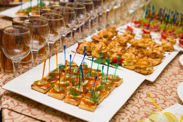 catering banquet table, Canapes on restaurant table, catering, buffet, canapés, stemware, snacks, glasses with juice, champagne glasses