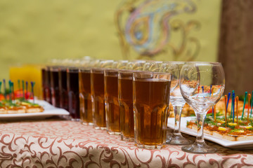catering banquet table, Canapes on restaurant table, catering, buffet, canapés, stemware, snacks, glasses with juice, champagne glasses