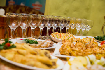 catering banquet table, Canapes on restaurant table, catering, buffet, canapés, stemware, snacks, glasses with juice, champagne glasses