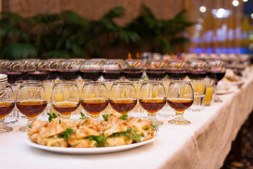 catering banquet table, Canapes on restaurant table, catering, buffet, canapés, stemware, snacks, glasses with juice, champagne glasses