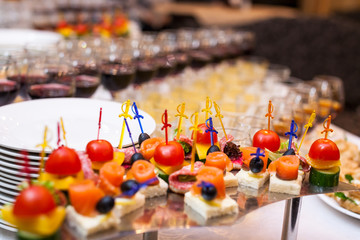 catering banquet table, Canapes on restaurant table, catering, buffet, canapés, stemware, snacks, glasses with juice, champagne glasses