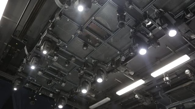 Floodlights, head, scanners on the ceiling of a small theater or concert hall