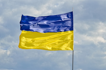 State flag of Ukraine against the blue sky. Yellow and blue symbol of freedom, patriotism and unbowed.