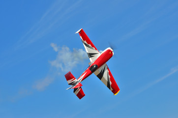 Flying the plane performs aerobatics in the sky - obrazy, fototapety, plakaty