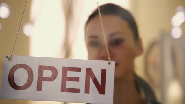 Open sign hanging on the door of shop