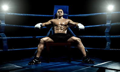 Fototapeta na wymiar boxer on boxing ring, tired time-out