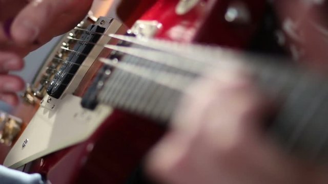 Man playing electric guitar with bend technique