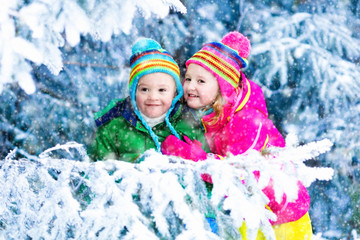 Kids playing in snowy forest