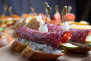 Bruschetta crostini set on a wooden tray. Composition of Italian cuisine.