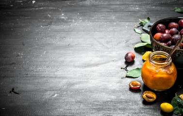 Fresh puree of ripe plums with green leaves.