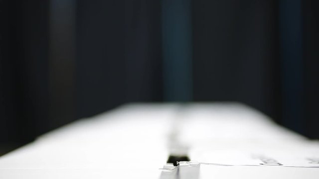 Unrecognizable people cast their vote during elections in a voting station