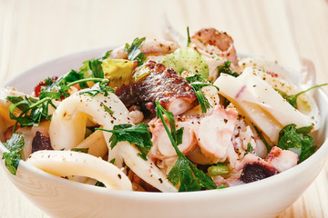 Seafood salad in white bowl