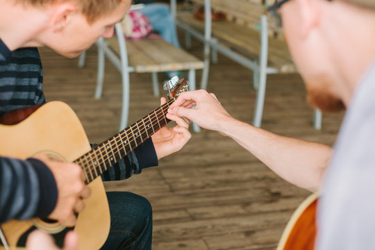 Learning to play the guitar. Music education and extra-curricular lessons.