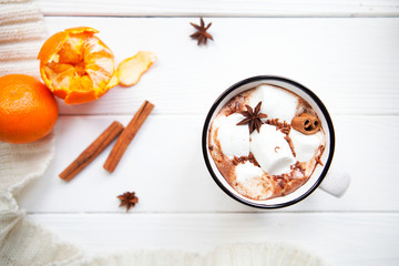 Hot chocolate with marshmallows in a ceramic cup, cinnamon stick