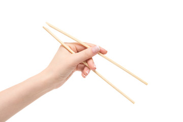 Female hand holds chopsticks on a white background.